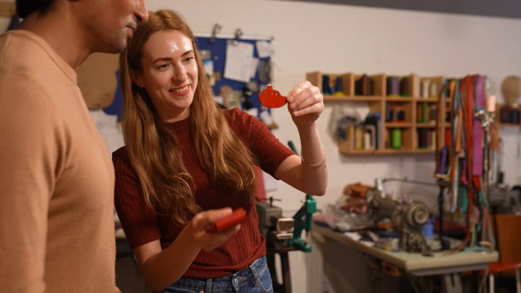 A leathercraft workshop experience on the Isle of Thanet featuring an instructor showing a handmade leather boat.
