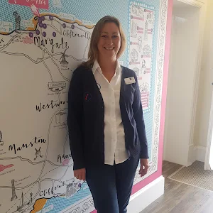 Lady leaning against map graphic on wall