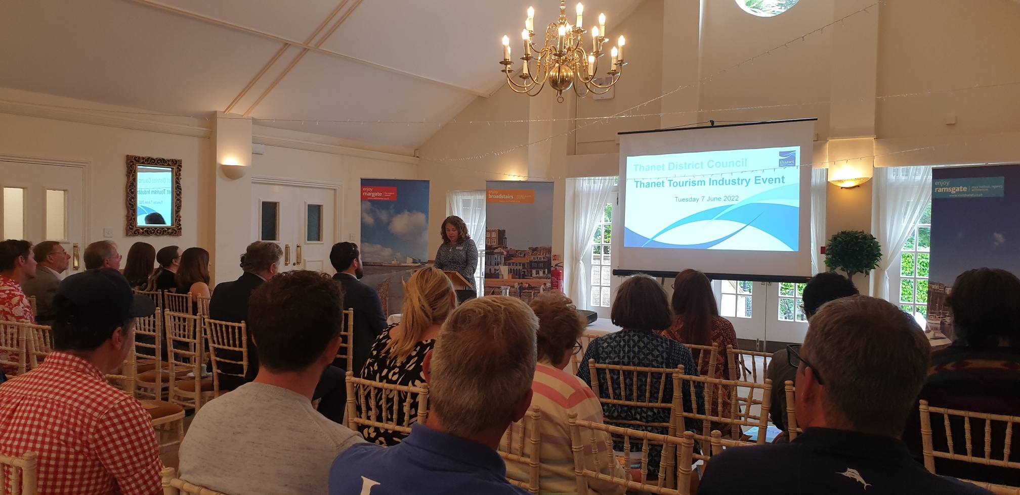 Speaker presenting at the Thanet Tourism Industry Event to a seated audience.