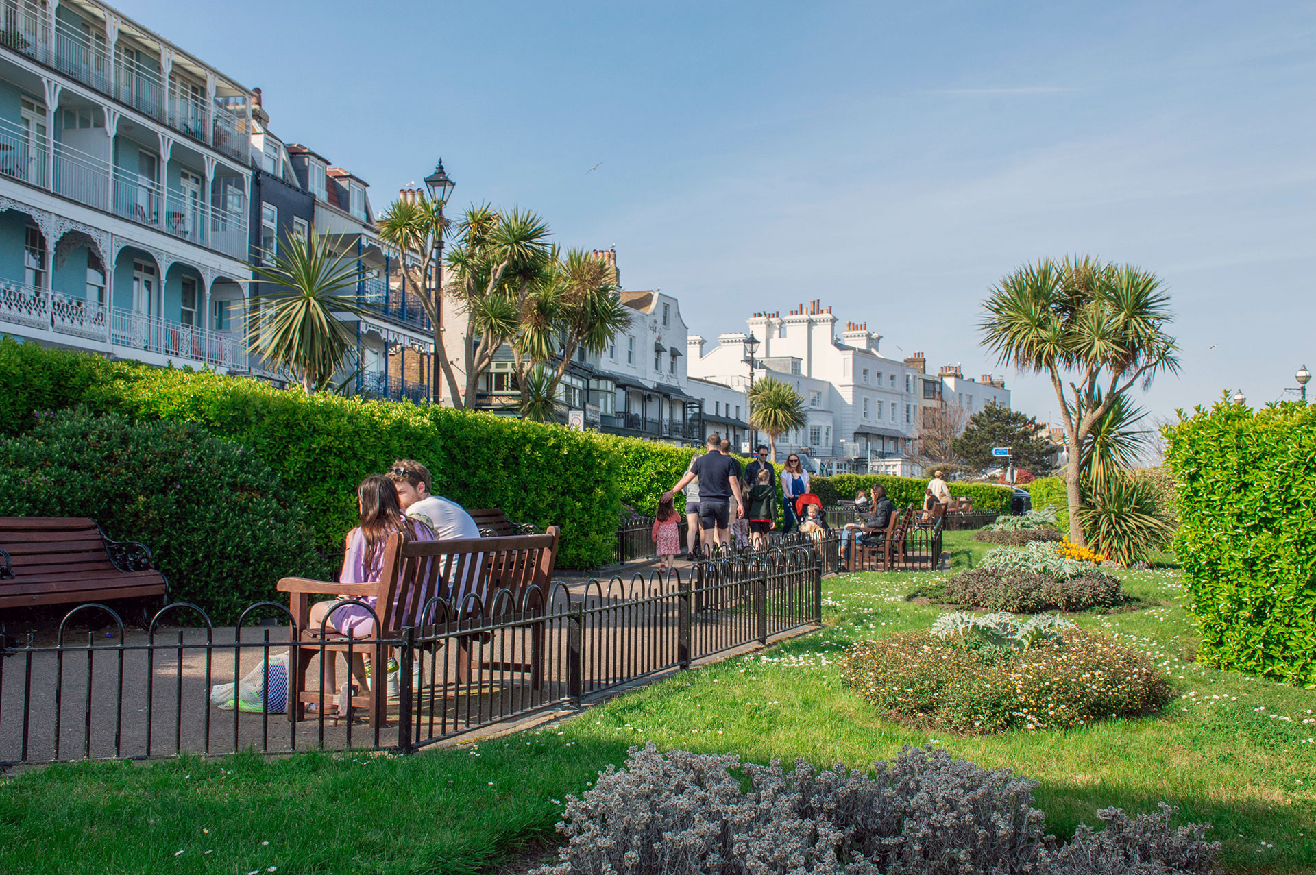 People enjoying the landscaped lawns and coastal views at Victoria Gardens, Broadstairs.