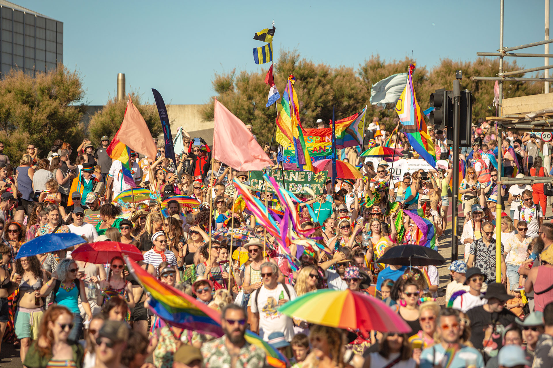 Bright colourful parade with banners, flags and umbrellas