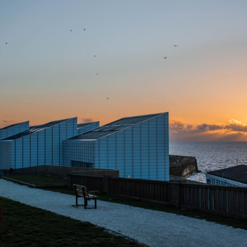 Sunset over the sea behind Margate's Turner Contemporary from cliff top