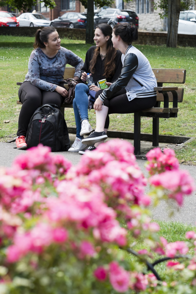 Students-sat-on-bench-with-flowers-in-foreground-Margate-Language-School-P.-Credit-@VisitThanet