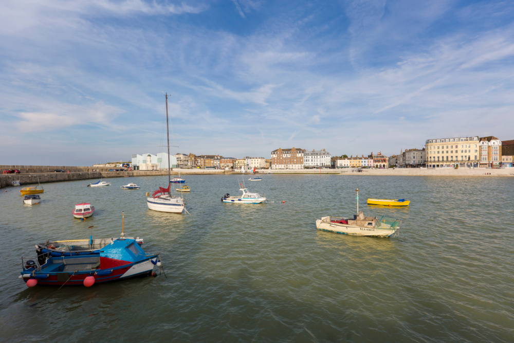 Margate Harbour with boats and seafront. Credit @VisitThanet